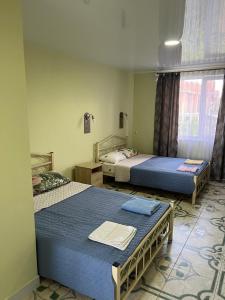 a bedroom with two beds and a window at Green guest house in Chornomorsk