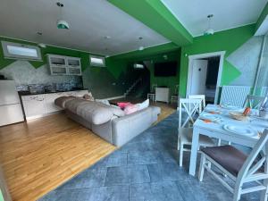a living room with a couch and a table at Premont Bran GuestHouse in Bran +48 photos