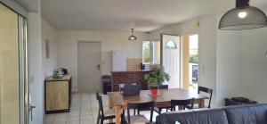 a kitchen and dining room with a table and chairs at Gîte la Blanchère in Saint-Herblon