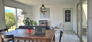 a living room with a table with a laptop on it at Gîte la Blanchère in Saint-Herblon +8 photos