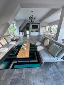 a living room with a couch and a table at Premont Bran GuestHouse in Bran