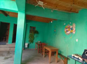 a blue room with a table and a basketball hoop at Alojamiento Lidia in Iruya