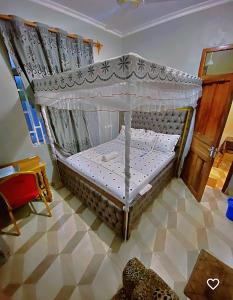 a small bed in a room with a canopy at Triple A visitors in Kilindoni +63 photos