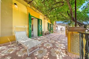 a bench sitting outside of a yellow building at Villa Charme Lipari in Lipari