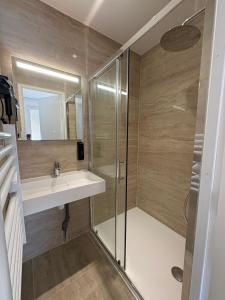 a bathroom with a sink and a shower at Rovotel - Le Rove in Le Rove