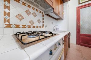 a kitchen with a stove and a sink at Villa Charme Lipari in Lipari +23 photos