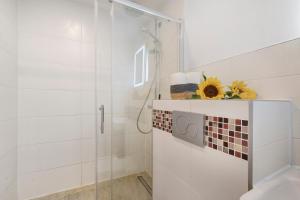 a white bathroom with a shower and a toilet at Apartment Melody in Oberkochen
