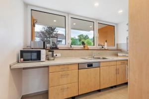 a kitchen with a sink and a microwave at Apartment Melody in Oberkochen