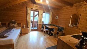 a bedroom with a bed and a table in a room at Appartement Gugganig in Flattach