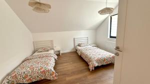 a bedroom with two beds and a window at Nikola apartman in Arilje