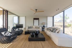 a living room with white furniture and large windows at Villa Gara exclusive luxury villa with heated pool in Lajares