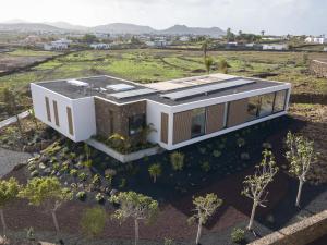 an aerial view of a house in a field at Villa Gara exclusive luxury villa with heated pool in Lajares