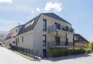 a large brick building with a black roof at Ferienwohnung Stern 3 Scharbeutz in Scharbeutz