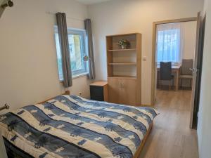 a bedroom with a bed and a desk and a chair at 386 Apartman in Písek