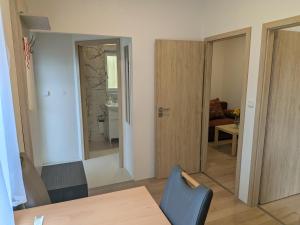a living room with a table and a blue chair at 386 Apartman in Písek