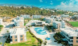 an aerial view of a resort with buildings at Luxury Sea & Pool View Apt at Caesar Cliff Esentepe in Perivolia tou Trikomou