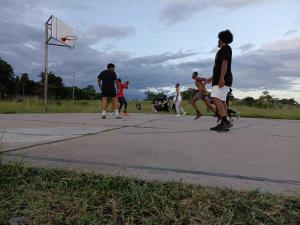 a group of young men playing basketball on a court at Amazon half london in Boma la Ngombe
