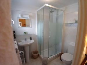 a bathroom with a shower and a toilet and a sink at Número 9 in Medina Sidonia +27 photos