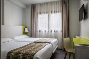 a hotel room with a bed and a window at Estival Cristina in Pas de la Casa