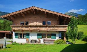 a wooden house with a balcony on top of it at Obernberg in Aurach bei Kitzbuhel