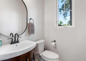 a bathroom with a sink and a toilet and a mirror at The Farmhouse in Darby +8 photos