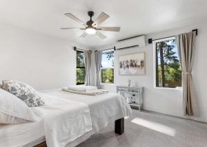 a white bedroom with a bed and a ceiling fan at The Farmhouse in Darby