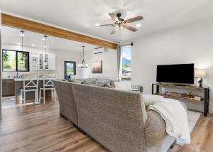 a living room with a couch and a tv and a kitchen at The Farmhouse in Darby