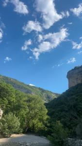 a view of a valley with trees and a mountain at les Trois Cœurs in Mison