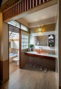 a bathroom with a sink and a toilet and a tub at Khaokhoherbary OrganicFarm&Resort in Khao Kho