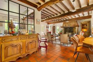 a living room with a large wooden dresser and a fireplace at L'abri des Côtes - Veules les Roses in Pleine-sève