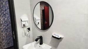 a bathroom with a sink and a mirror at Sky Airport Hotel - فندق سما المطار in Al Mawşil +63 photos