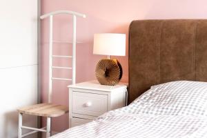 a bedroom with a bed and a lamp and a ladder at Ferienwohnung Ostseestübchen in Scharbeutz