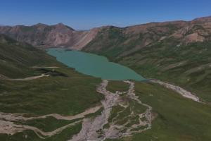 an aerial view of a lake in the mountains at Gulbubu Guest house in Kochkorka