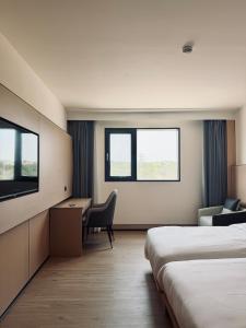 a hotel room with two beds and a desk and a tv at Hotel Nueva Europa Valencia in Valencia