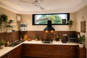 a kitchen with a sink and a window at Minara Meadows Kasauli in Dharampur