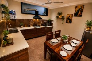 a kitchen and dining room with a table and chairs at Minara Meadows Kasauli in Dharampur +6 photos