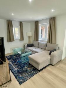 a living room with a couch and a coffee table at La Maison Caroline in Surbourg