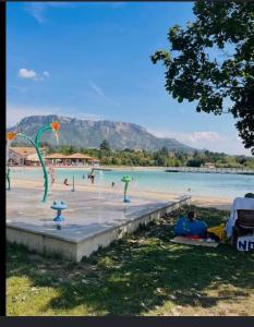 a group of people on a beach with a body of water at les Trois Cœurs in Mison