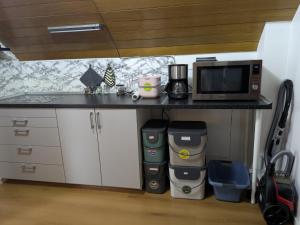 a kitchen with a counter with a microwave and coffee makers at Ferienapartment Erdmann in Münster