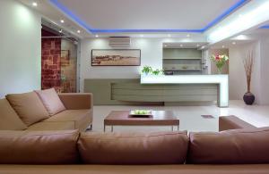 a living room with a couch and a table at Minos Village in Agia Marina Nea Kydonias