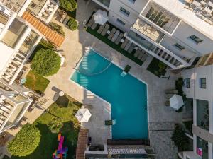 an overhead view of a swimming pool in a building at Minos Village in Agia Marina Nea Kydonias
