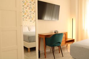 a bedroom with a desk and a bed and a mirror at Guest House Scarlatti in Battipaglia