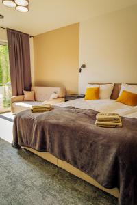 a bedroom with two large beds and a couch at Oaza Brzozowa in Stradomia Wierzchnia