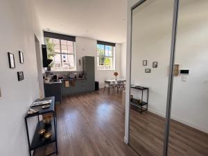 a living room with a large glass door to a kitchen at Le Côté Cour in Dole