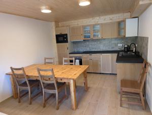 a kitchen with a wooden table and chairs at Chalet Kočí in Kořenov