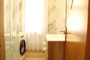 a bathroom with a sink and a washing machine at Guest House Scarlatti in Battipaglia