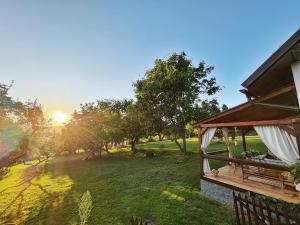 a house with a gazebo in a field at Chalúpka Polom in Hnúšťa