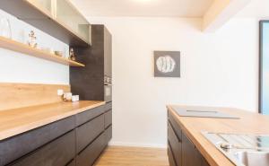 a kitchen with white walls and wooden countertops at Ferienhaus Westside Niendorf in Häven +35 photos