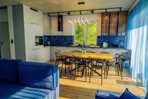 a kitchen and dining room with a table and chairs at Oaza Brzozowa in Stradomia Wierzchnia