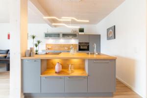 a kitchen with a counter with a sink at Ferienhaus Eastside - Niendorf in Häven
